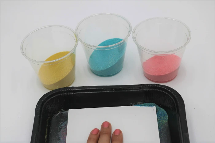 It's easy to create mess-free sand art with adhesive boards!